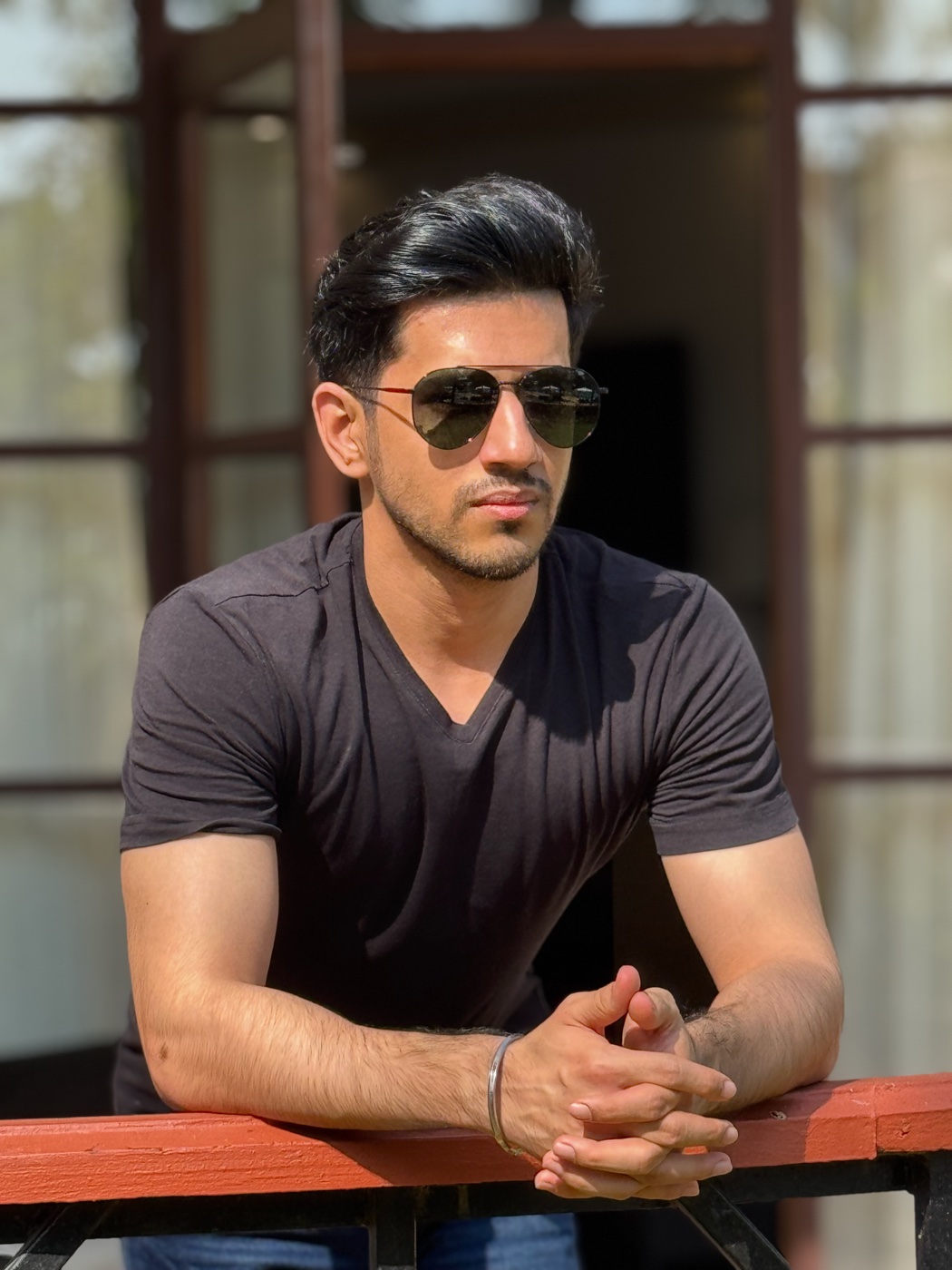 Raghav Mehra outdoors, leaning on a terracotta railing